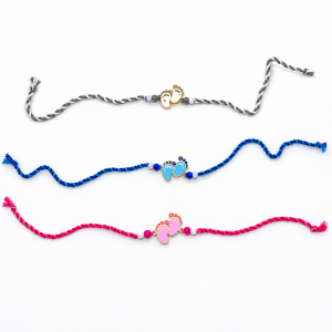 Baby feet rakhi in grey, blue & pink for raksha bandhan.