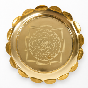 Polished brass plate featuring an engraved Shree Yantra pattern and a scalloped petal border.