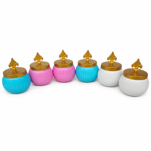 A set of colorful, round metal dry fruit nuts storage jars with fluted designs and gold-tone decorative lids.