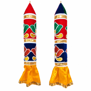 Decorative fabric pillars, featuring colorful satin cloth with sparkly floral patchworks and flared yellow bases.