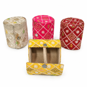 Cylindrical embroidered bangle boxes with snap-button closures and internal partitions.