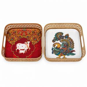 A set of decorative square metal trays featuring traditional Pichwai peacock and Kamadhenu motifs.